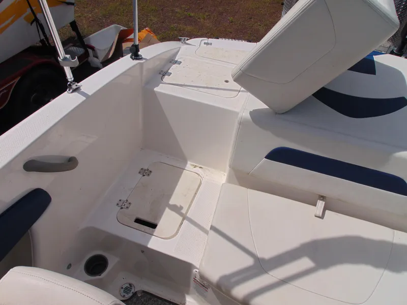 Slide: The Image of 2015 Chaparral 18 H2O Sport boat interior with white and blue seating. - 14