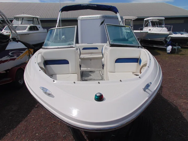 Slide: The Image of 2015 Chaparral 18 H2O Sport boat with open bow seating, displayed outdoors. - 2