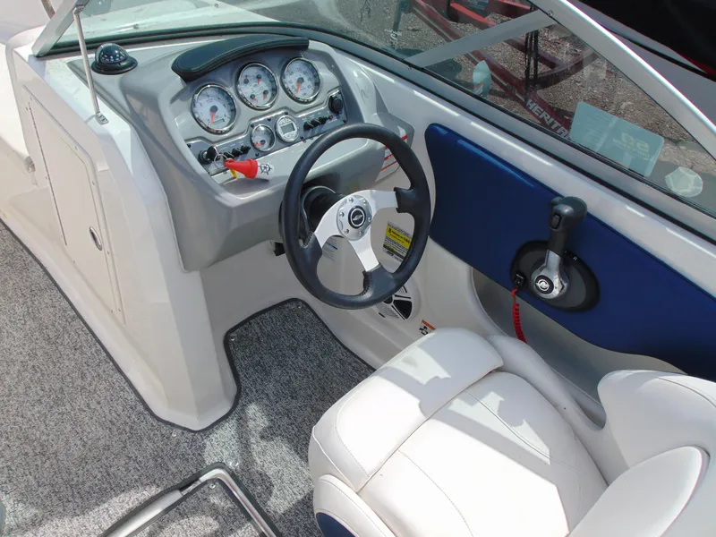 Slide: The Image of 2015 Chaparral 18 H2O Sport boat interior with steering wheel and dashboard controls. - 7