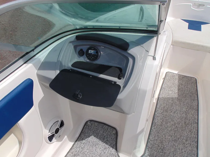 Slide: The Image of 2015 Chaparral 18 H2O Sport boat interior with dashboard and seating area. - 9