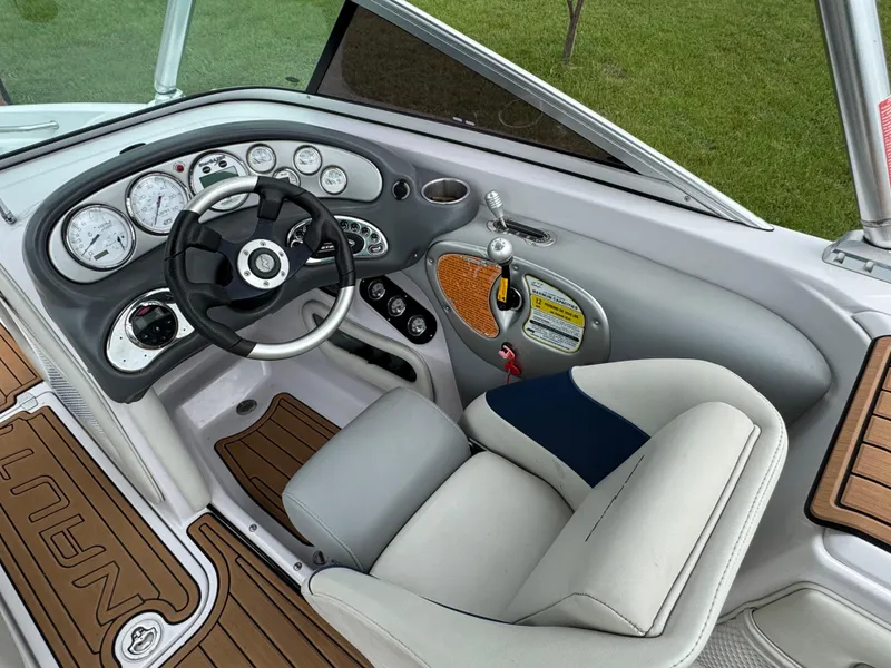 Slide: The Image of 2007 Nautique Super Air Nautique 230 boat interior with steering wheel and dashboard controls. - 10