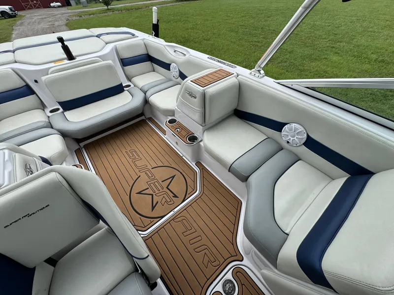 Slide: The Image of 2007 Nautique Super Air Nautique 230 interior with white and blue seating, teak flooring. - 14