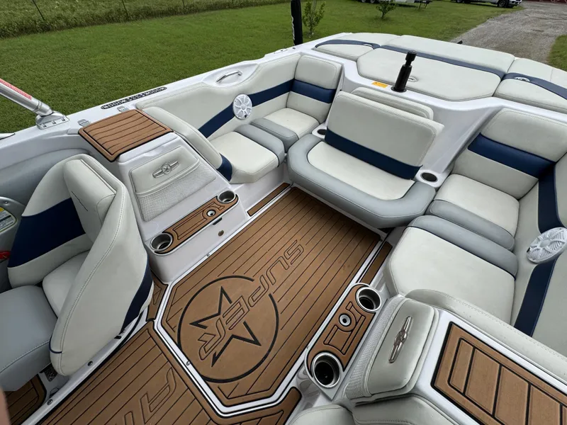 Slide: The Image of 2007 Nautique Super Air Nautique 230 interior with white and blue seating, teak flooring. - 15
