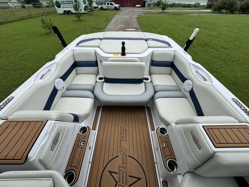 Slide: The Image of 2007 Nautique Super Air Nautique 230 boat interior with white seating and wood accents. - 16