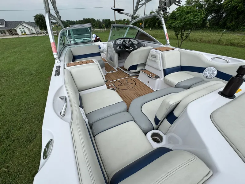 Slide: The Image of 2007 Nautique Super Air Nautique 230 interior with white and gray seating, open layout. - 18