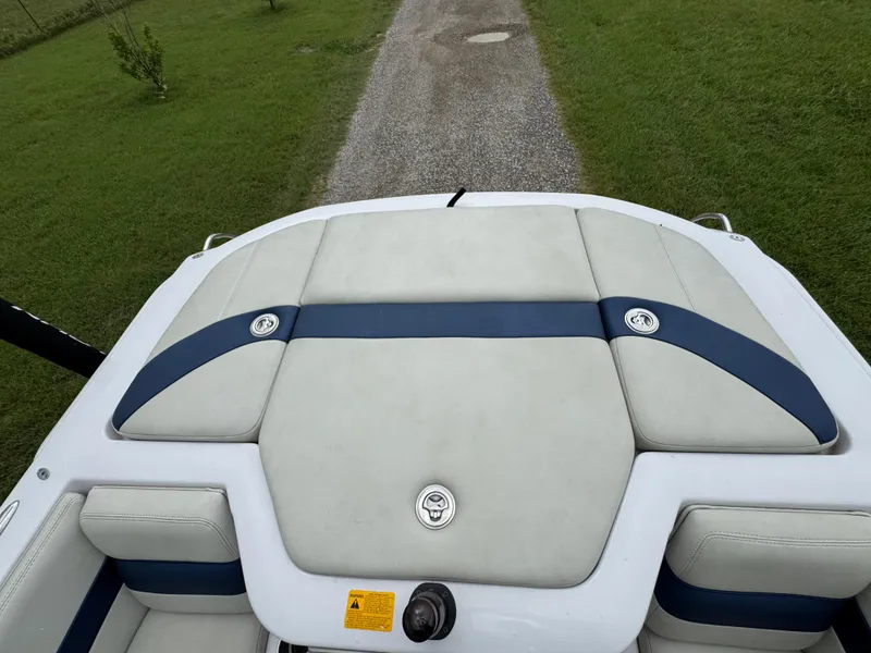 Slide: The Image of 2007 Nautique Super Air Nautique 230 boat interior with cushioned seating and blue accents. - 20