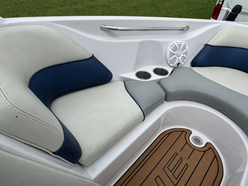 Slide: The Image of 2007 Nautique Super Air Nautique 230 interior with cushioned seating and cup holders. - 6