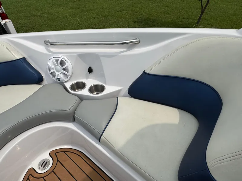 Slide: The Image of 2007 Nautique Super Air Nautique 230 boat interior with cushioned seating and cup holders. - 7