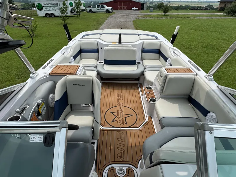 Slide: The Image of 2007 Nautique Super Air Nautique 230 boat interior with cushioned seating and teak flooring. - 8