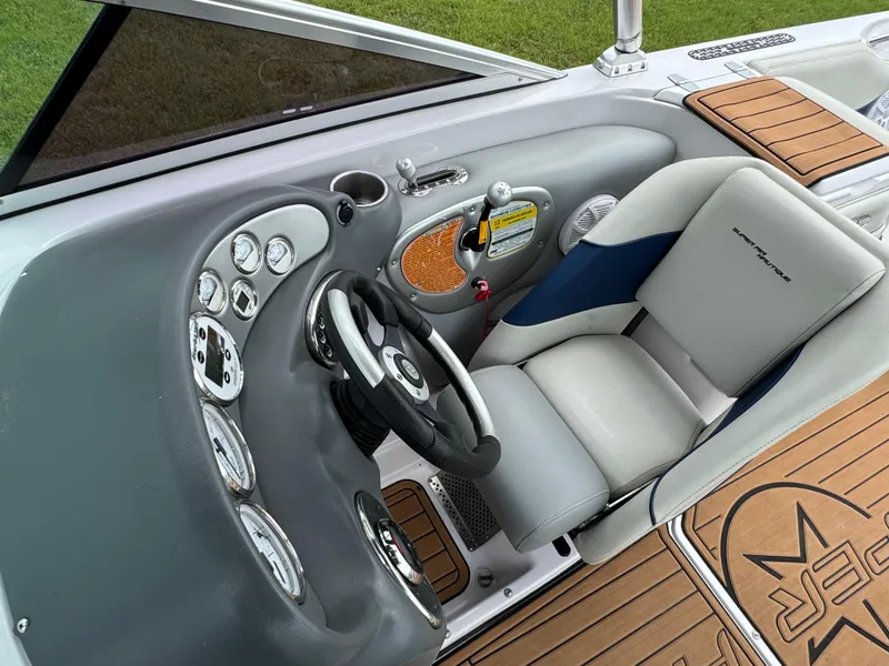 Slide: The Image of 2007 Nautique Super Air Nautique 230 boat cockpit with steering wheel and control panel. - 9