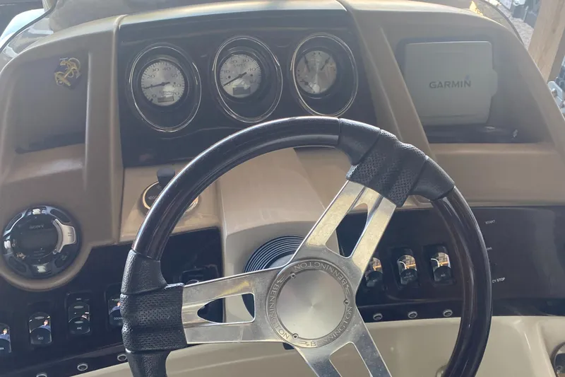 Slide: The Image of 2012 Bennington R22 dashboard with steering wheel and Garmin navigation system. - 2