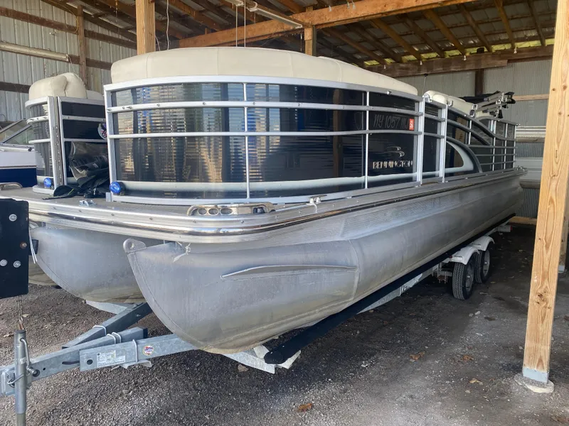 Slide: The Image of 2012 Bennington R22 pontoon boat stored in a covered area on a trailer. - 3