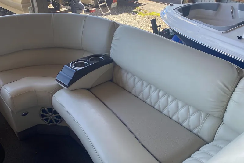 Slide: The Image of 2012 Bennington R22 boat interior with beige seating and cup holders. - 5