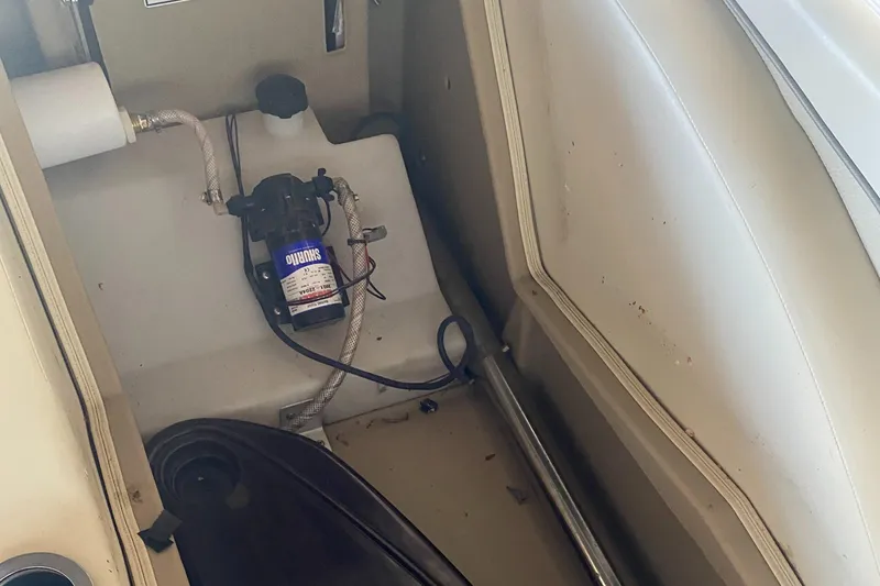 Slide: The Image of 2012 Bennington R22 boat interior showing storage compartment and pump system. - 6