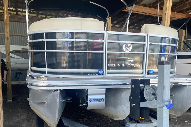 Slide: The Image of 2012 Bennington R22 pontoon boat stored in a covered dock. - 7