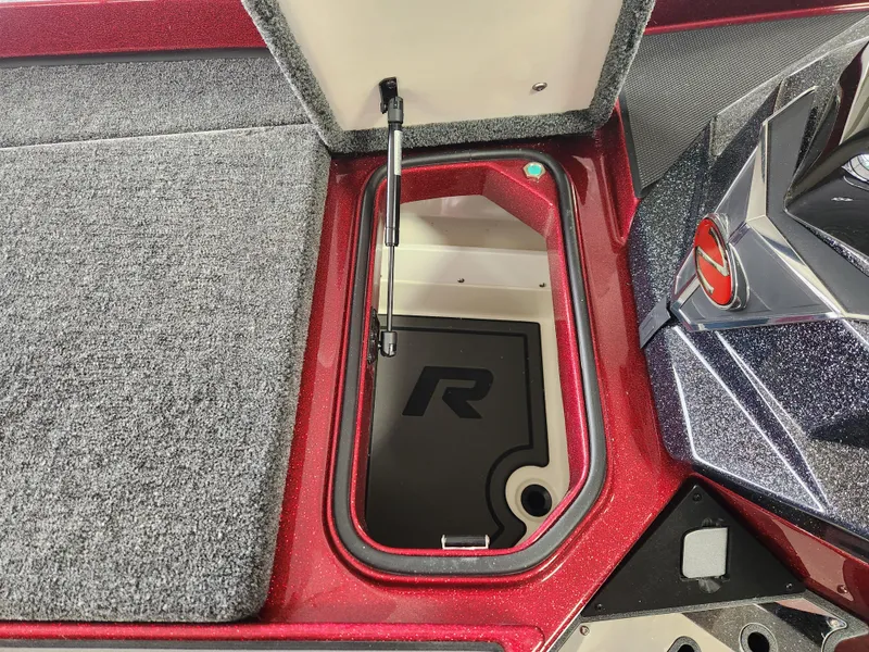 Slide: The Image of 2025 Ranger Z520R Cup-Equipped boat storage compartment with open lid and carpeted interior. - 12