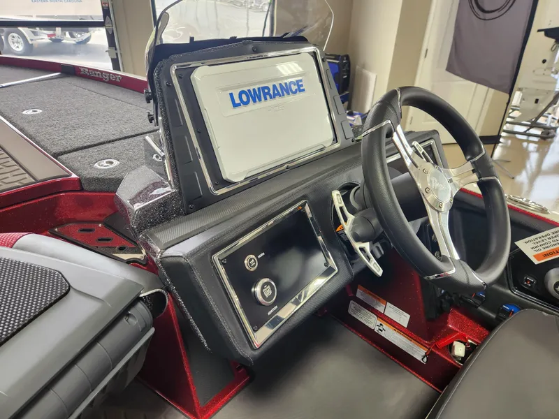 Slide: The Image of 2025 Ranger Z520R Cup-Equipped boat dashboard with Lowrance electronics and steering wheel. - 16