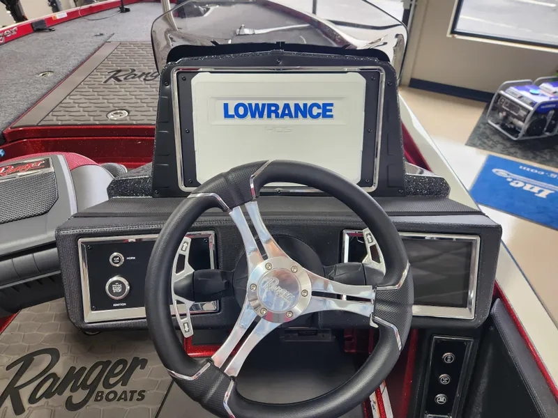 Slide: The Image of 2025 Ranger Z520R boat dashboard with Lowrance display and steering wheel. - 17