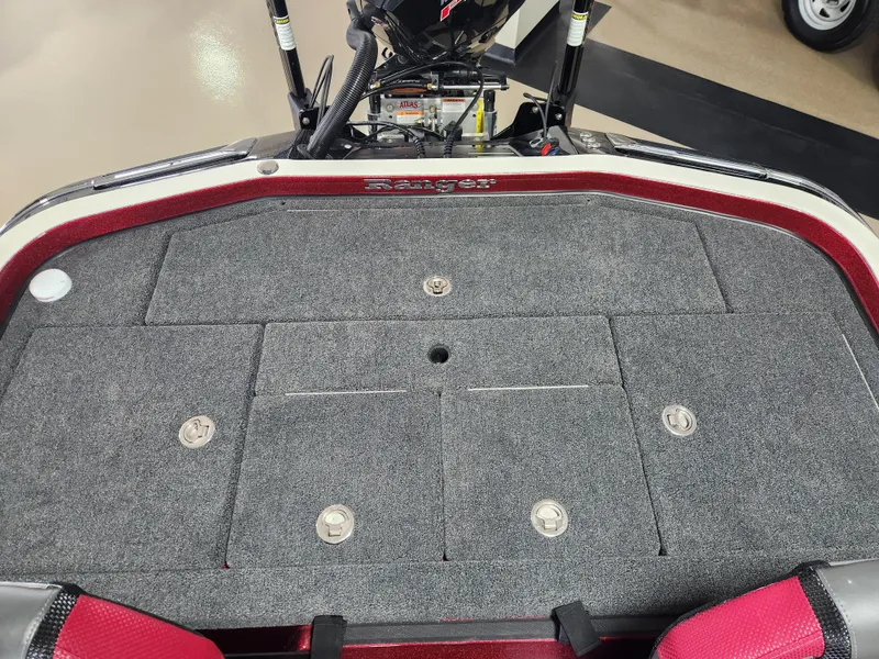 Slide: The Image of 2025 Ranger Z520R Cup-Equipped boat deck with storage compartments and red trim. - 18