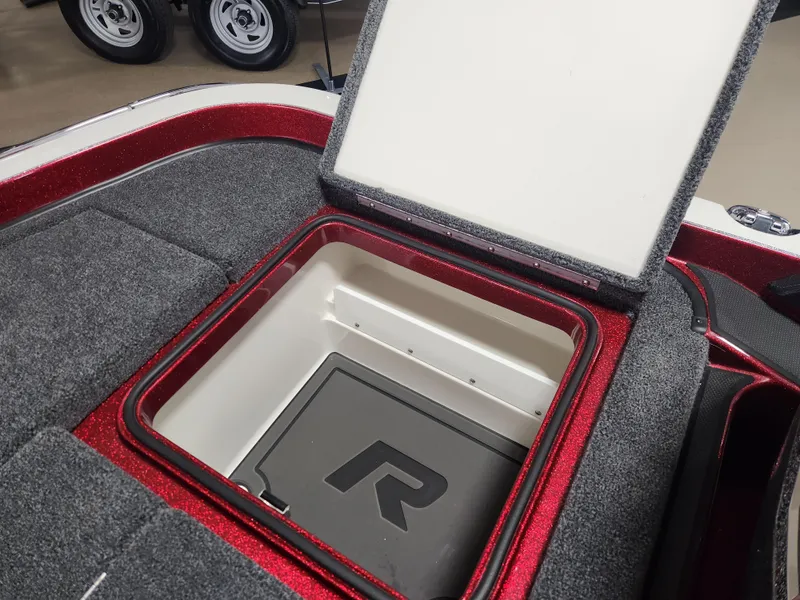 Slide: The Image of 2025 Ranger Z520R Cup-Equipped boat storage compartment with open lid, showcasing interior design. - 19