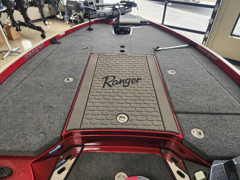 Slide: The Image of 2025 Ranger Z520R Cup-Equipped boat deck with gray carpet and red accents. - 7