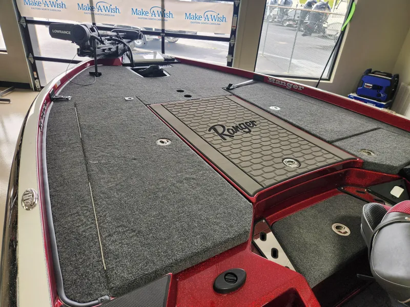 Slide: The Image of 2025 Ranger Z520R Cup-Equipped boat interior with carpeted deck and storage compartments. - 8