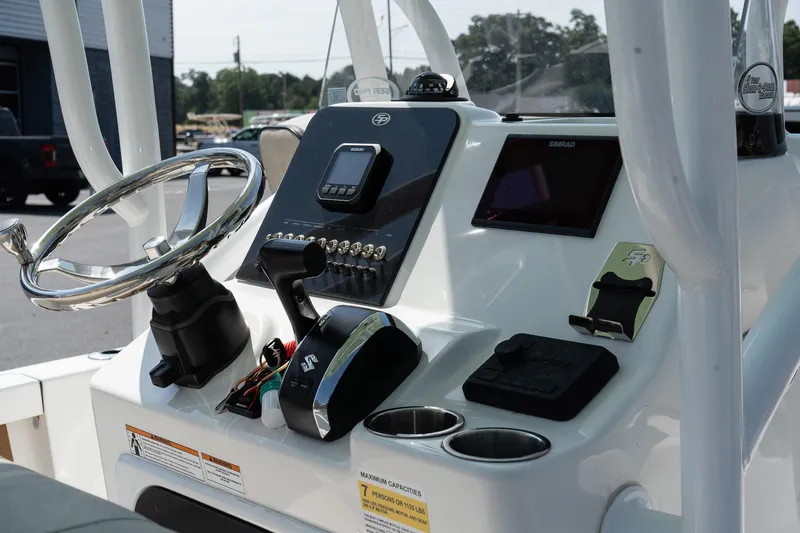 Slide: The Image of 2023 Sea Pro 208 Bay boat console with steering wheel and controls. - 16
