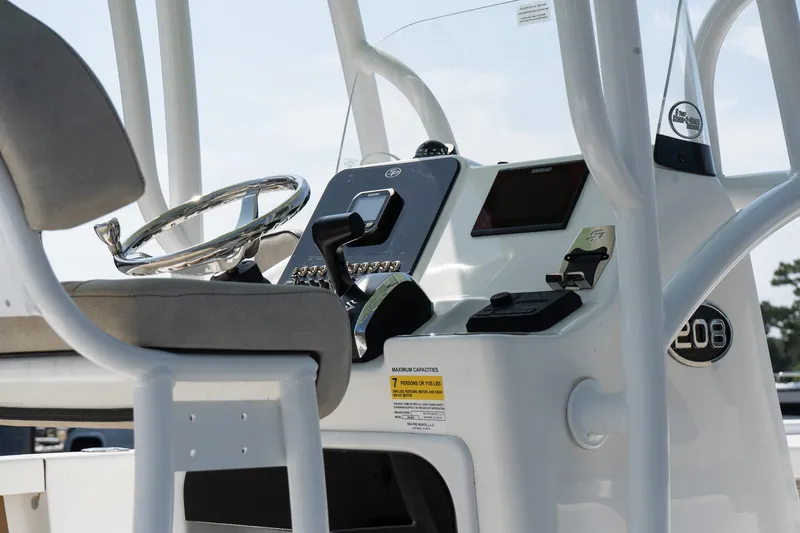 Slide: The Image of 2023 Sea Pro 208 Bay boat console with steering wheel and controls. - 9