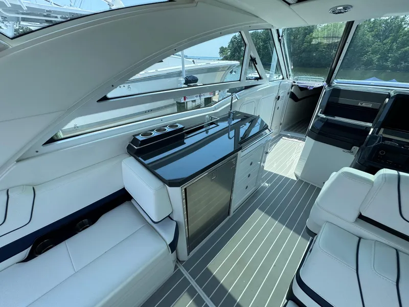 Slide: The Image of Interior of 2020 Formula 430 Super Sport Crossover yacht with sleek seating and kitchenette. - 8