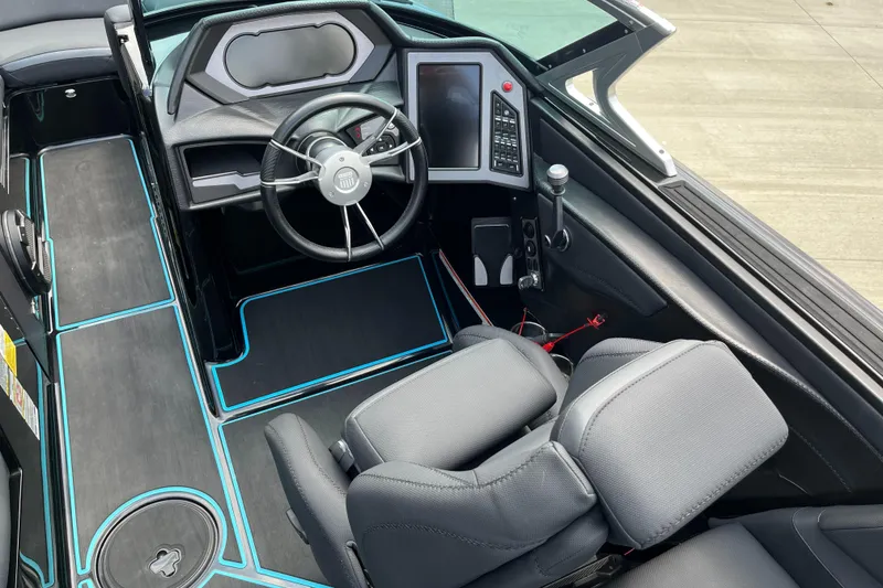 Slide: The Image of 2018 MasterCraft XStar boat interior with modern dashboard and steering wheel. - 10