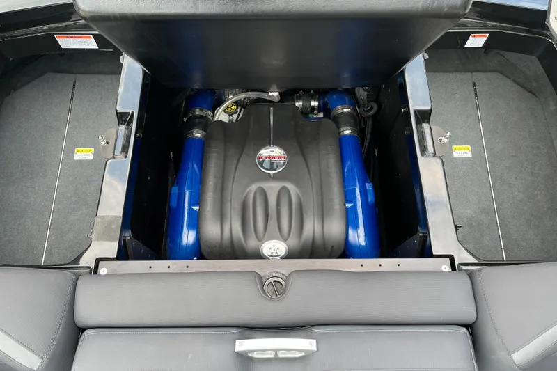 Slide: The Image of 2018 MasterCraft XStar engine compartment with blue accents and sleek design. - 14