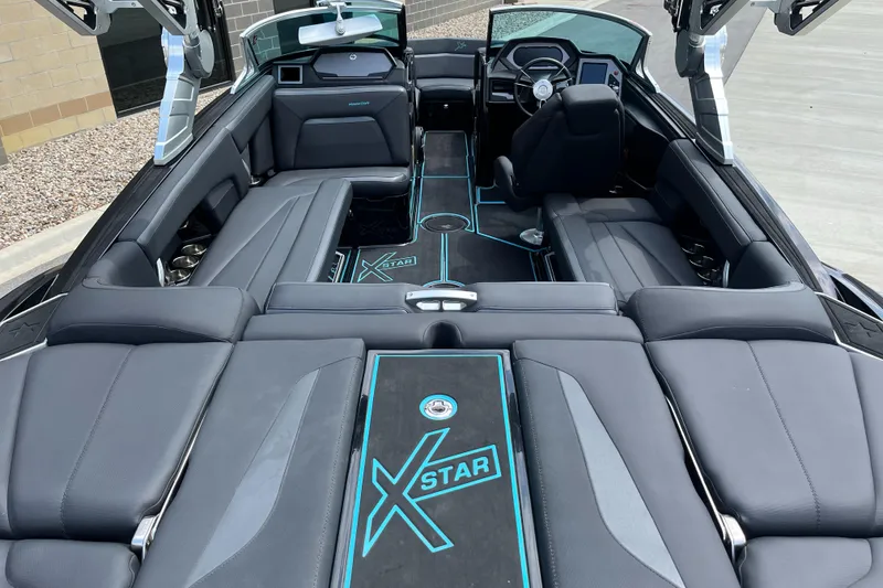 Slide: The Image of 2018 MasterCraft XStar interior with sleek black seating and modern dashboard design. - 9
