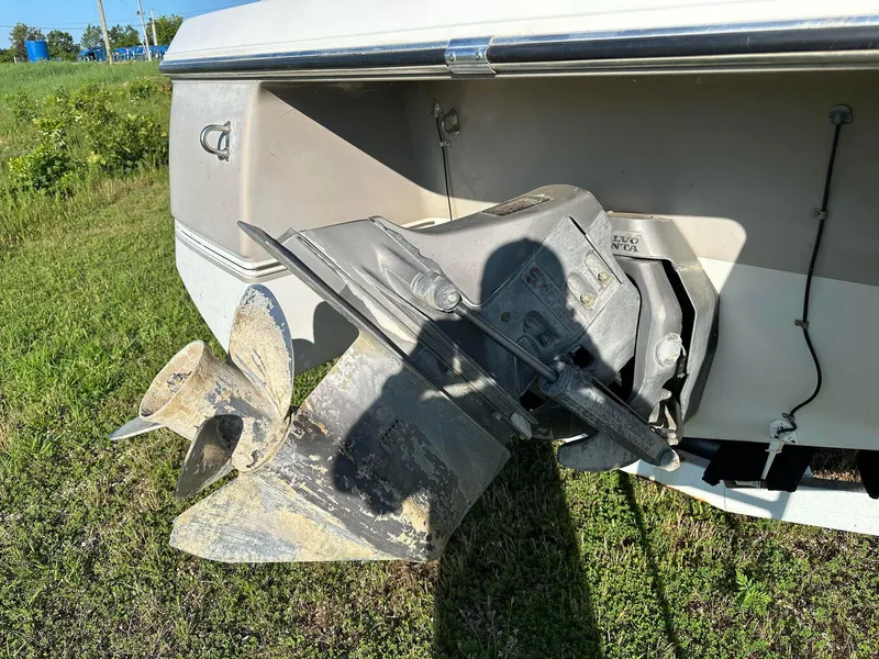 Slide: The Image of 1997 Four Winns 240 Horizon boat propeller and stern drive on grassy field. - 10