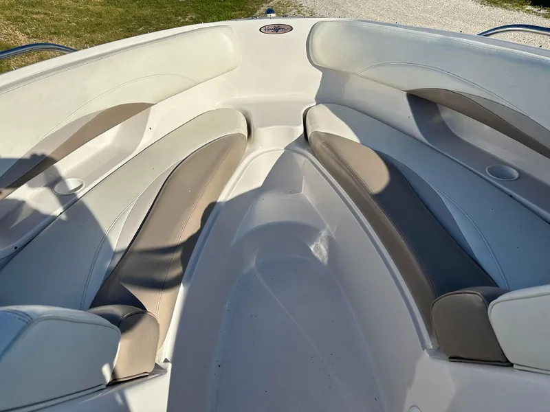 Slide: The Image of 1997 Four Winns 240 Horizon boat interior with cushioned seating and sleek design. - 11
