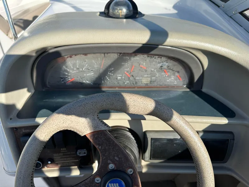 Slide: The Image of Steering wheel and dashboard of a 1997 Four Winns 240 Horizon boat. - 12