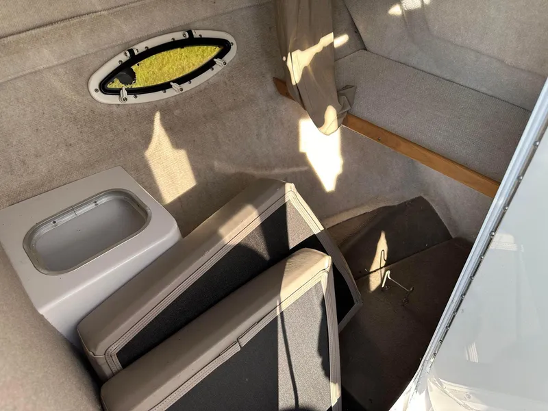 Slide: The Image of Interior of 1997 Four Winns 240 Horizon boat with seating and storage area. - 4
