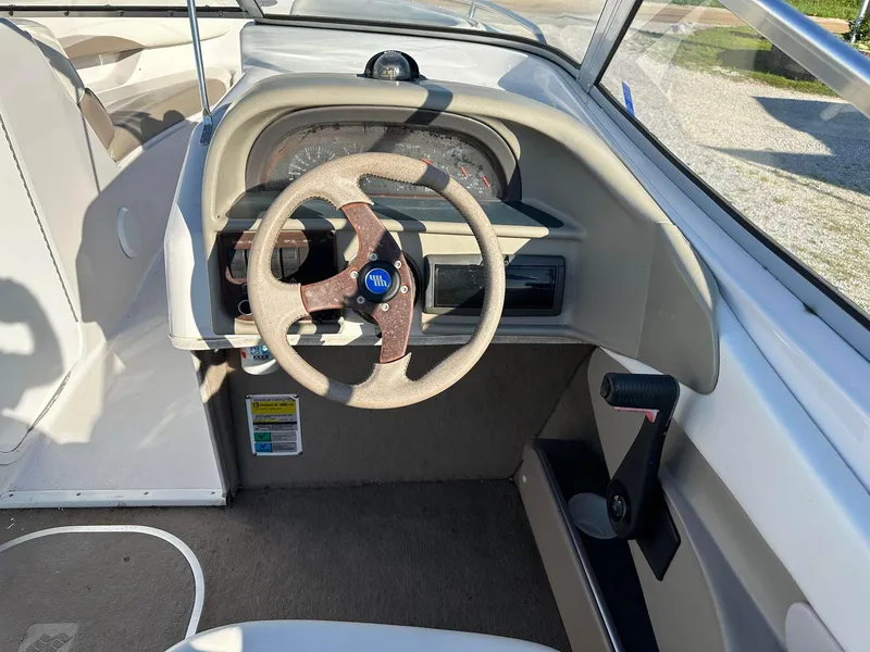 Slide: The Image of 1997 Four Winns 240 Horizon boat dashboard with steering wheel and controls. - 7