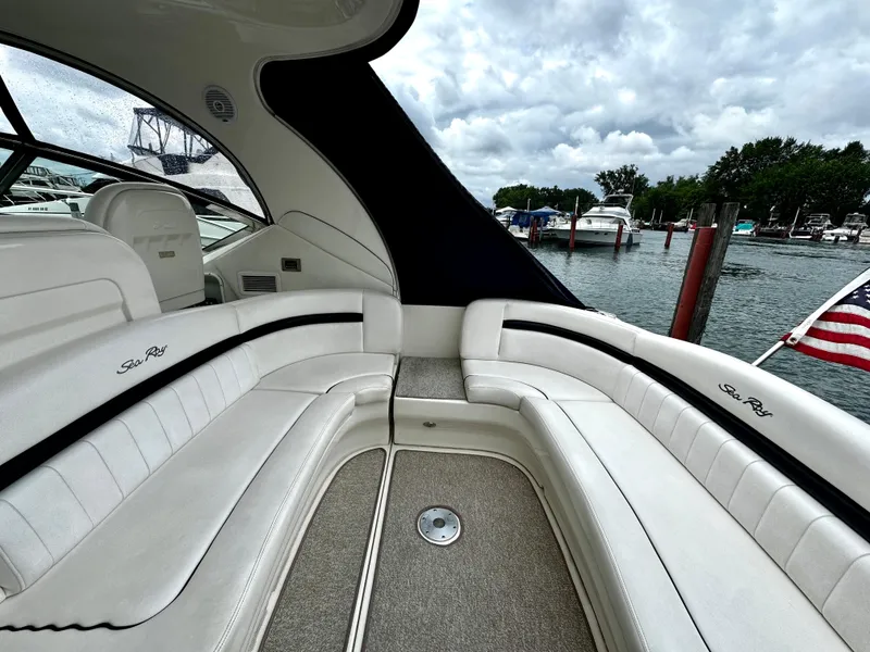 Slide: The Image of Interior of 2010 Sea Ray 40 Sundancer yacht with white seating and marina view. - 12