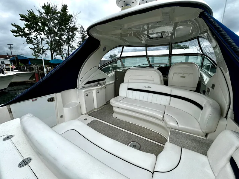 Slide: The Image of 2010 Sea Ray 40 Sundancer yacht interior with white seating and sleek design. - 13