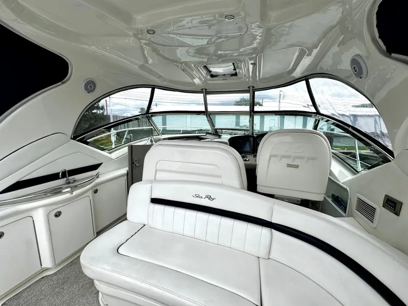 Slide: The Image of Interior of 2010 Sea Ray 40 Sundancer yacht with white seating and modern helm. - 14