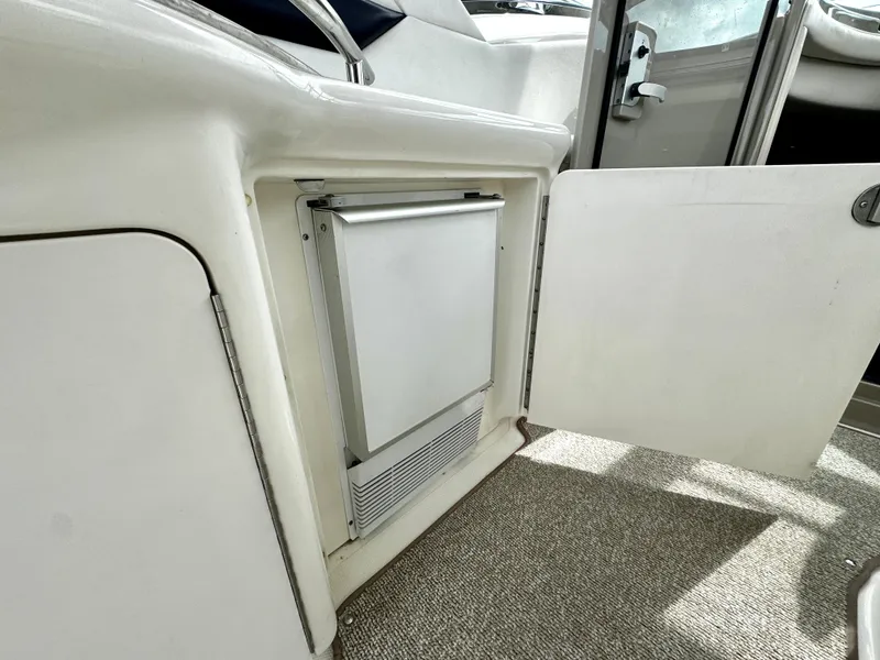 Slide: The Image of Open cabinet with mini fridge on 2010 Sea Ray 40 Sundancer yacht. - 17