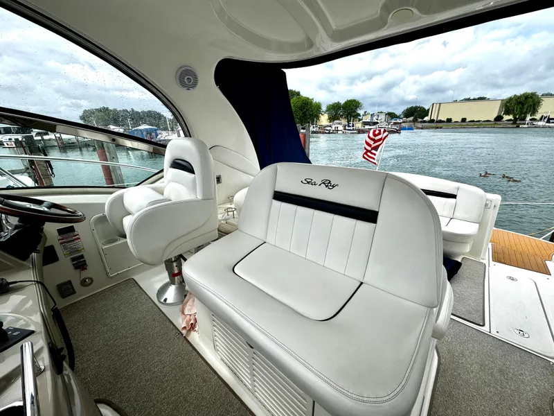 Slide: The Image of Interior of 2010 Sea Ray 40 Sundancer yacht with white seating and waterfront view. - 18