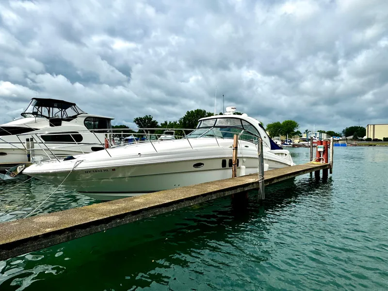 Slide: The Image of 2010 Sea Ray 40 Sundancer yacht docked at marina under cloudy sky. - 2