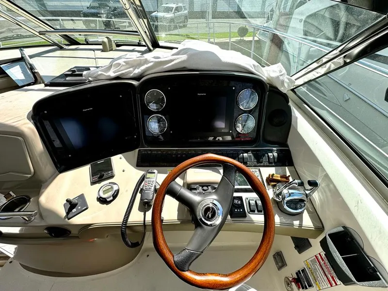 Slide: The Image of Helm of 2010 Sea Ray 40 Sundancer with wooden steering wheel and modern navigation instruments. - 20