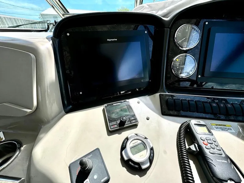 Slide: The Image of Dashboard of 2010 Sea Ray 40 Sundancer with navigation screens and controls. - 22