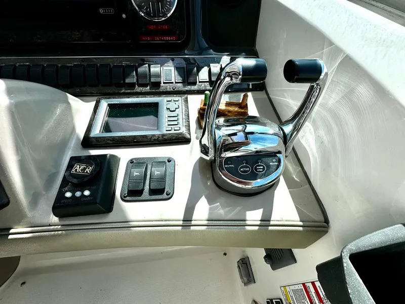 Slide: The Image of Control panel of a 2010 Sea Ray 40 Sundancer boat with throttle levers. - 23