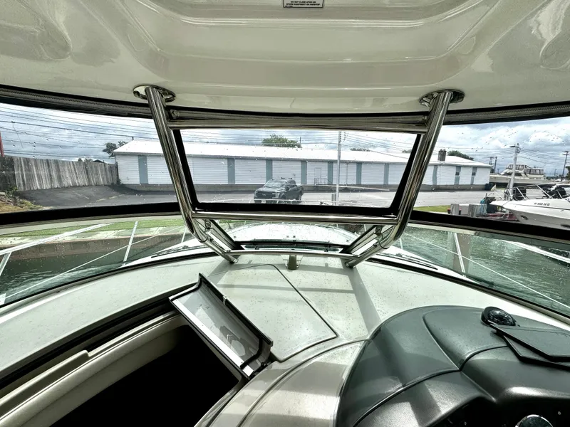 Slide: The Image of Interior view of 2010 Sea Ray 40 Sundancer yacht cockpit with marina background. - 25