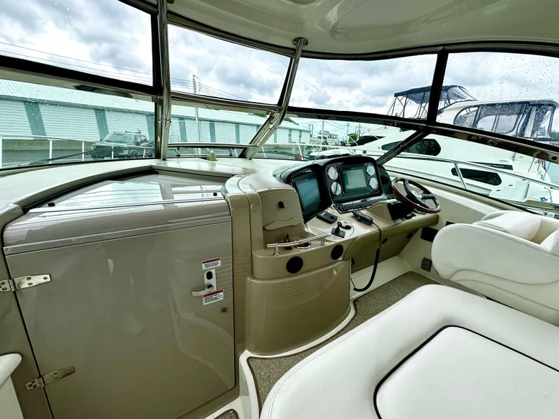 Slide: The Image of 2010 Sea Ray 40 Sundancer helm with modern navigation equipment and comfortable seating. - 26