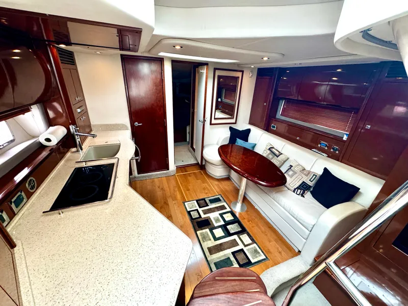 Slide: The Image of Luxurious interior of 2010 Sea Ray 40 Sundancer yacht with modern kitchen and seating area. - 27