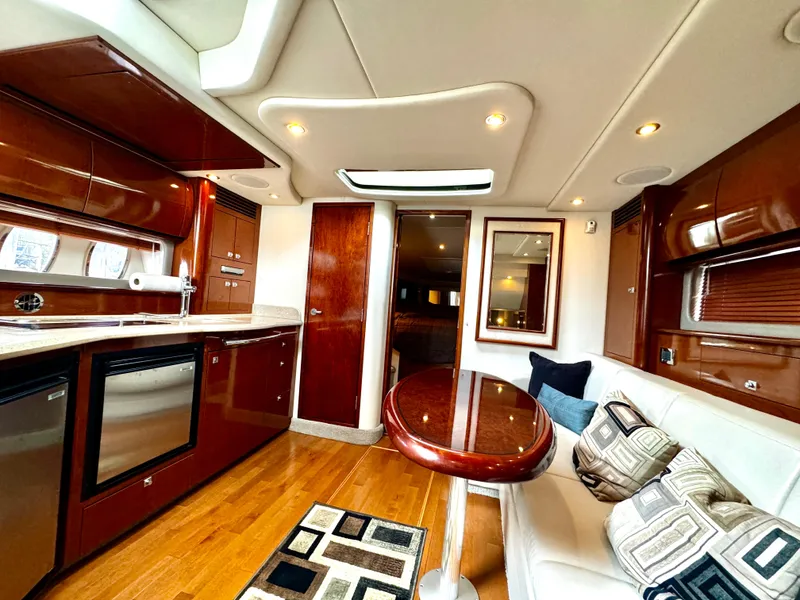 Slide: The Image of Luxurious interior of 2010 Sea Ray 40 Sundancer yacht with modern kitchen and seating area. - 28